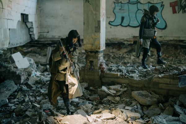 Young people searching through abandoned building